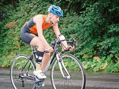 Woman riding bike with orthosis