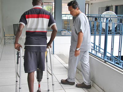 Haitan man with prosthetic leg excersising with prosthetist Kamil Leman