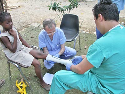 Disabled Haitan girl with prosthetist Kamil Leman